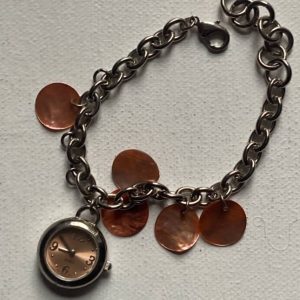Avon Cosmetics Bracelet With Watch Charm In Silver Tone Metal.